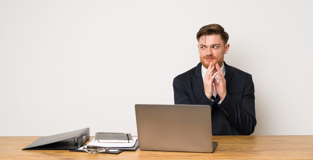 Businessman in a office scheming something