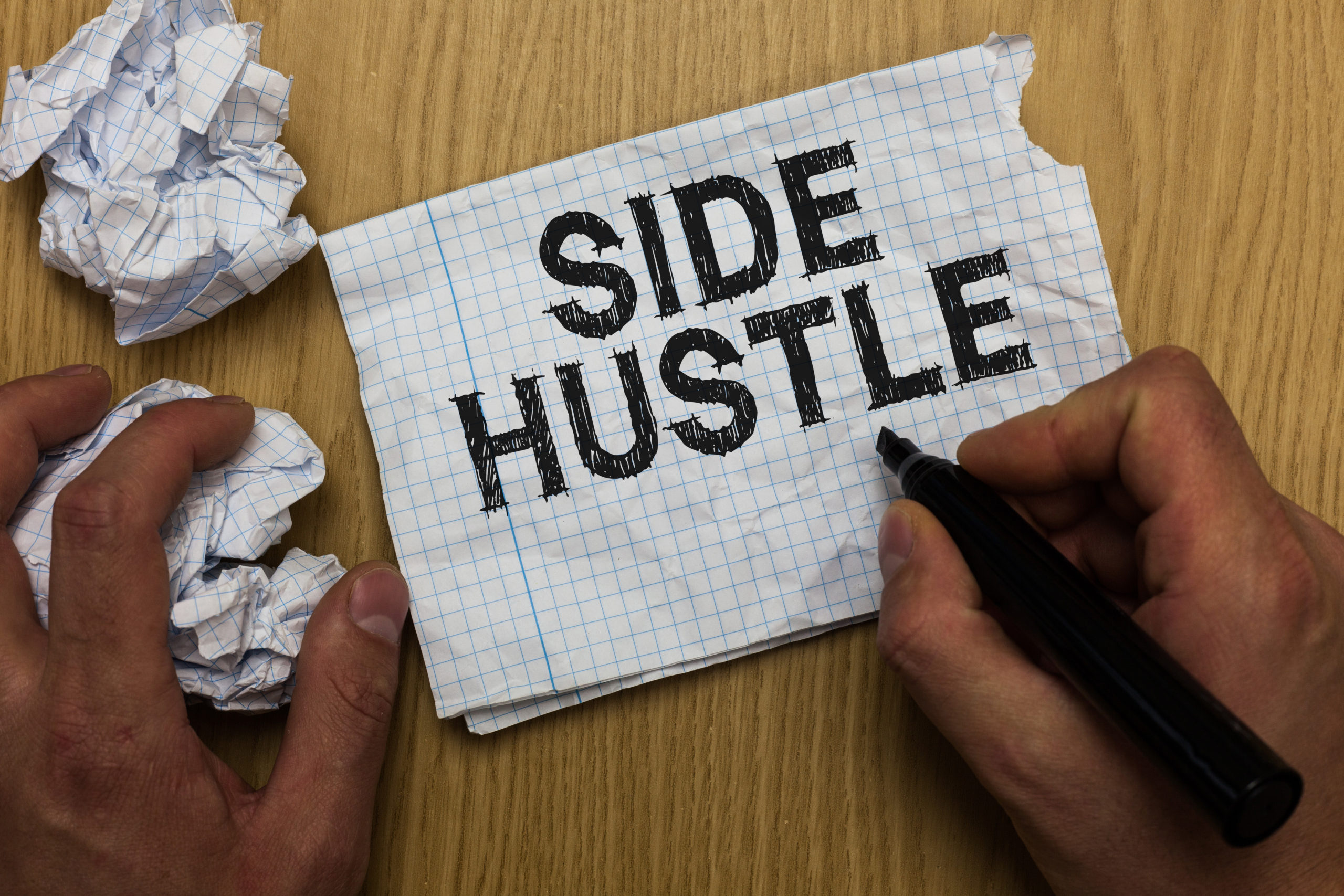 Writing note showing Side Hustle. Business photo showcasing way make some extra cash that allows you flexibility to pursue Man holding marker notebook paper crumpled papers several tries.