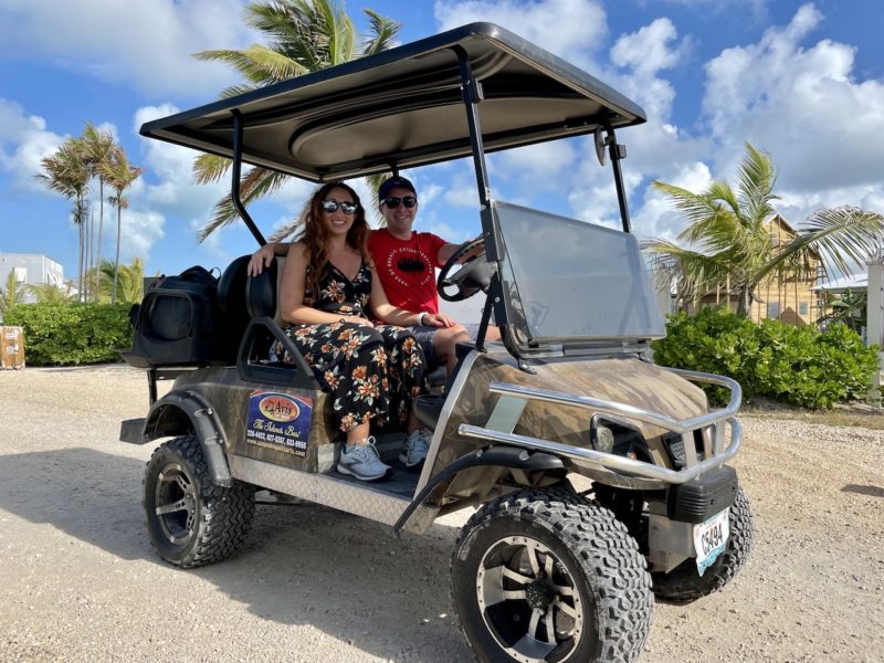 Man and woman sitting on a golf cart