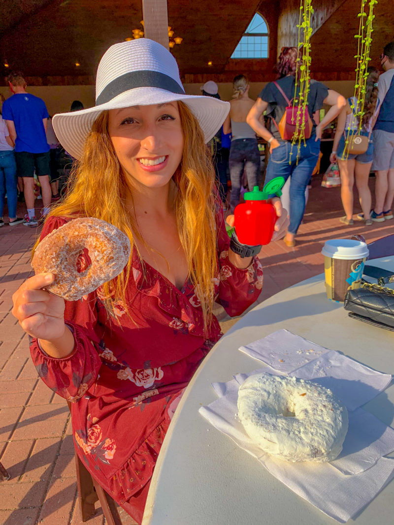 Women with donut and apple cider