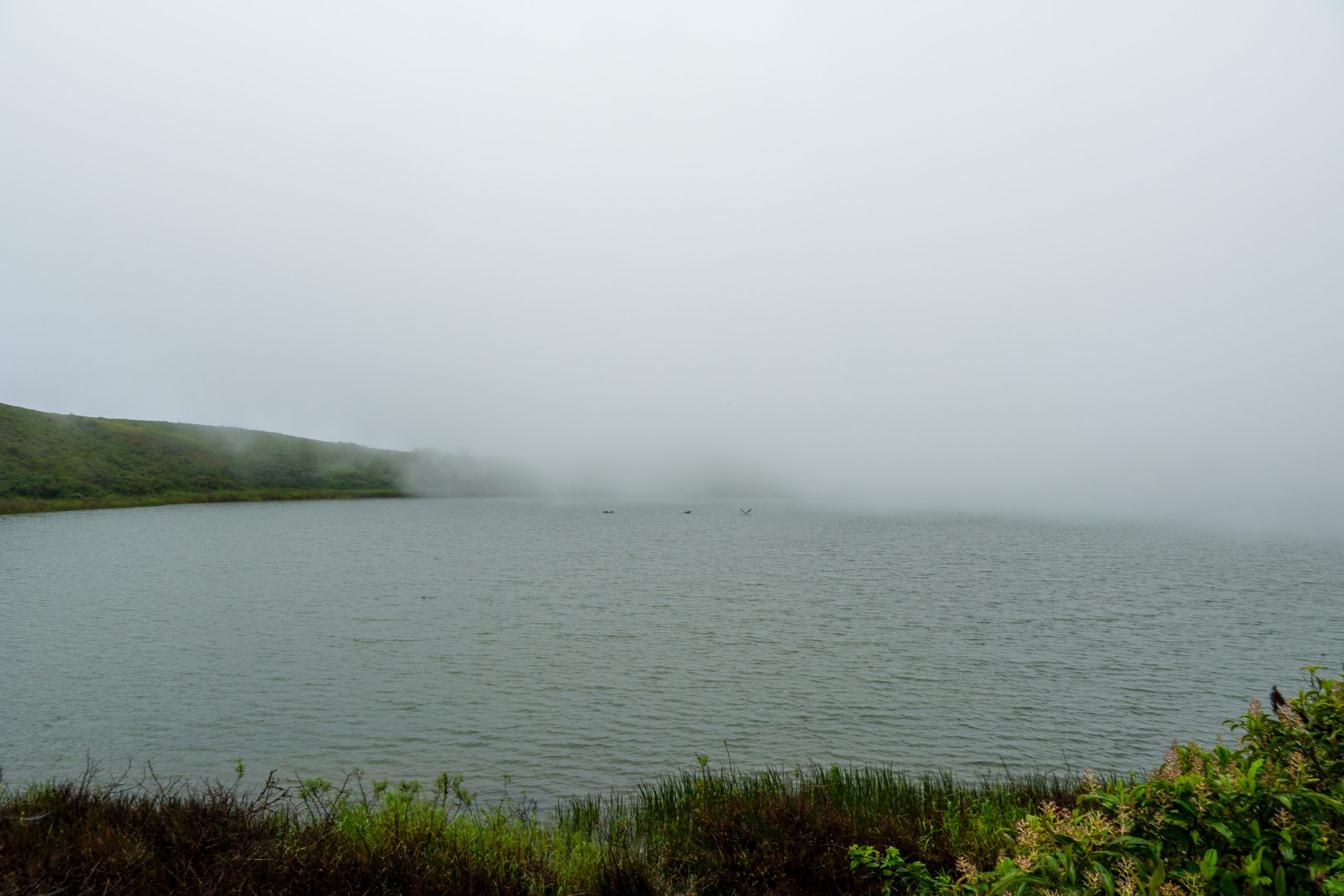 El Junco Lagoon with fog covering it