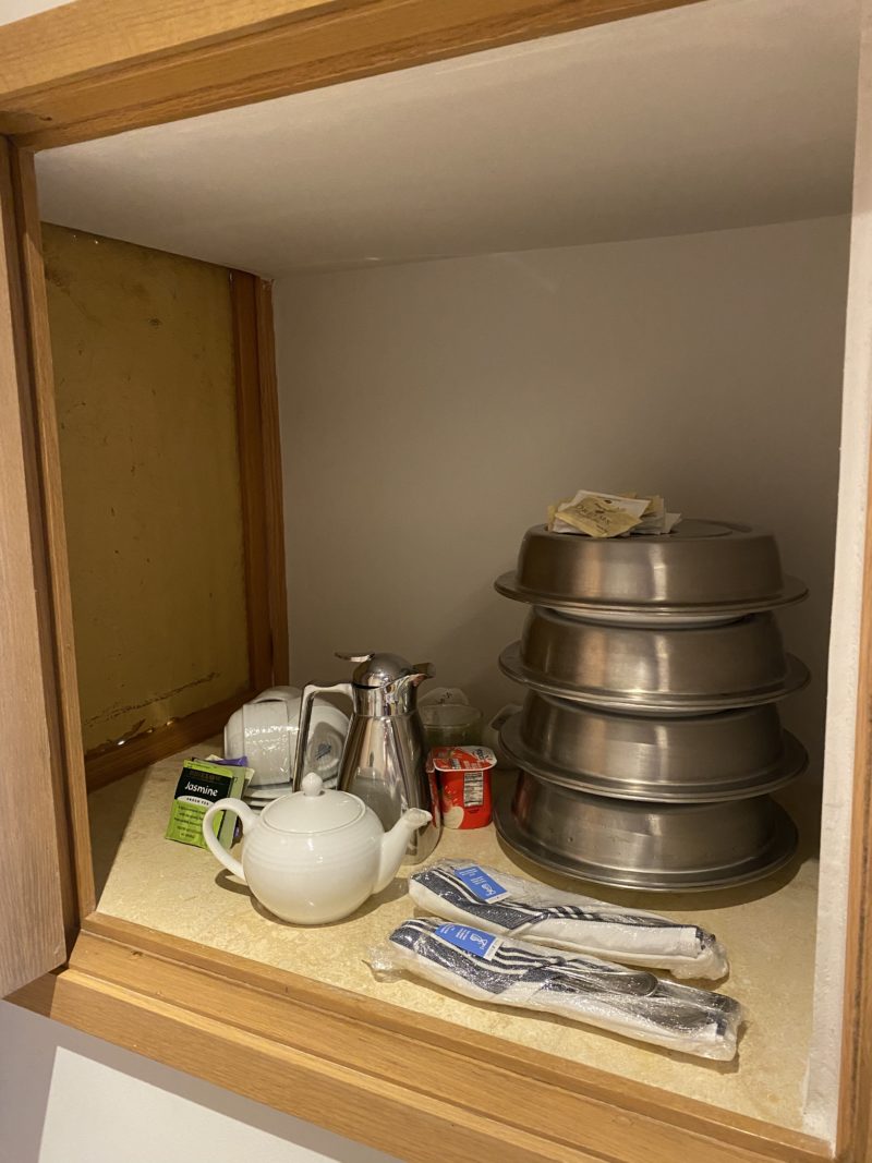 "Dream Box" in room filled with plates of food, tea and utensils.