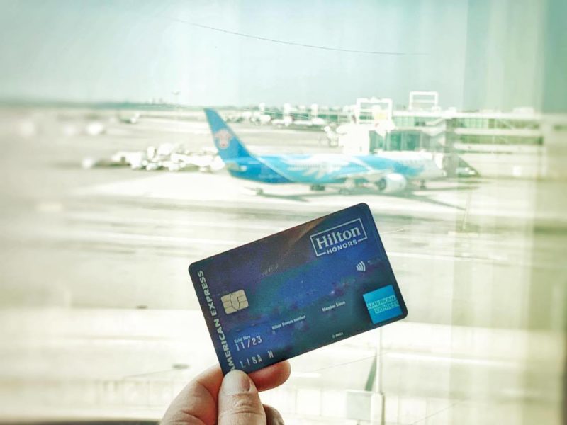 Hilton Honors Aspire Credit Card with airplane in background