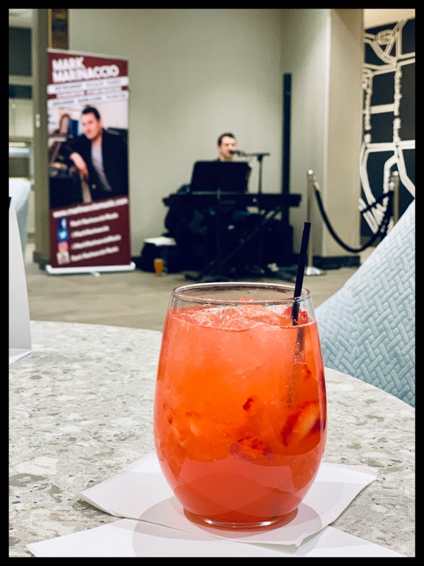 Pink cocktail with Mark Marinaccio singing in the background
