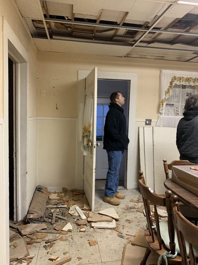 Guy looking at house torn apart for investment property renovations
