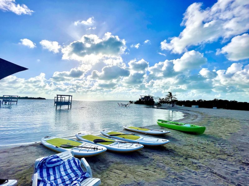 Kayaks and paddle boards along beach in Mahogany Bay