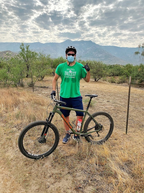 Man mountain with mountain bike and Catalina mountains in background