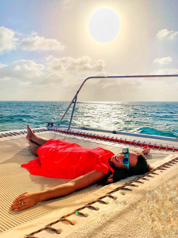 Woman laying on boat net