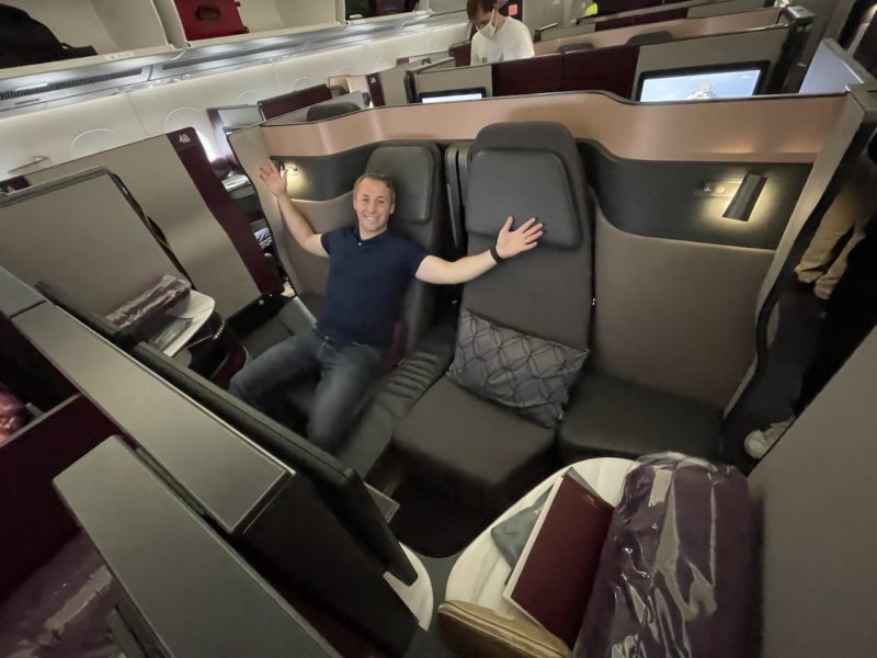 Man sitting in Qantas Q-Suites lay flat seat