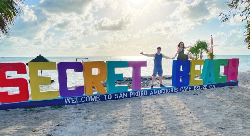 Couple posing with sign Secret Beach
