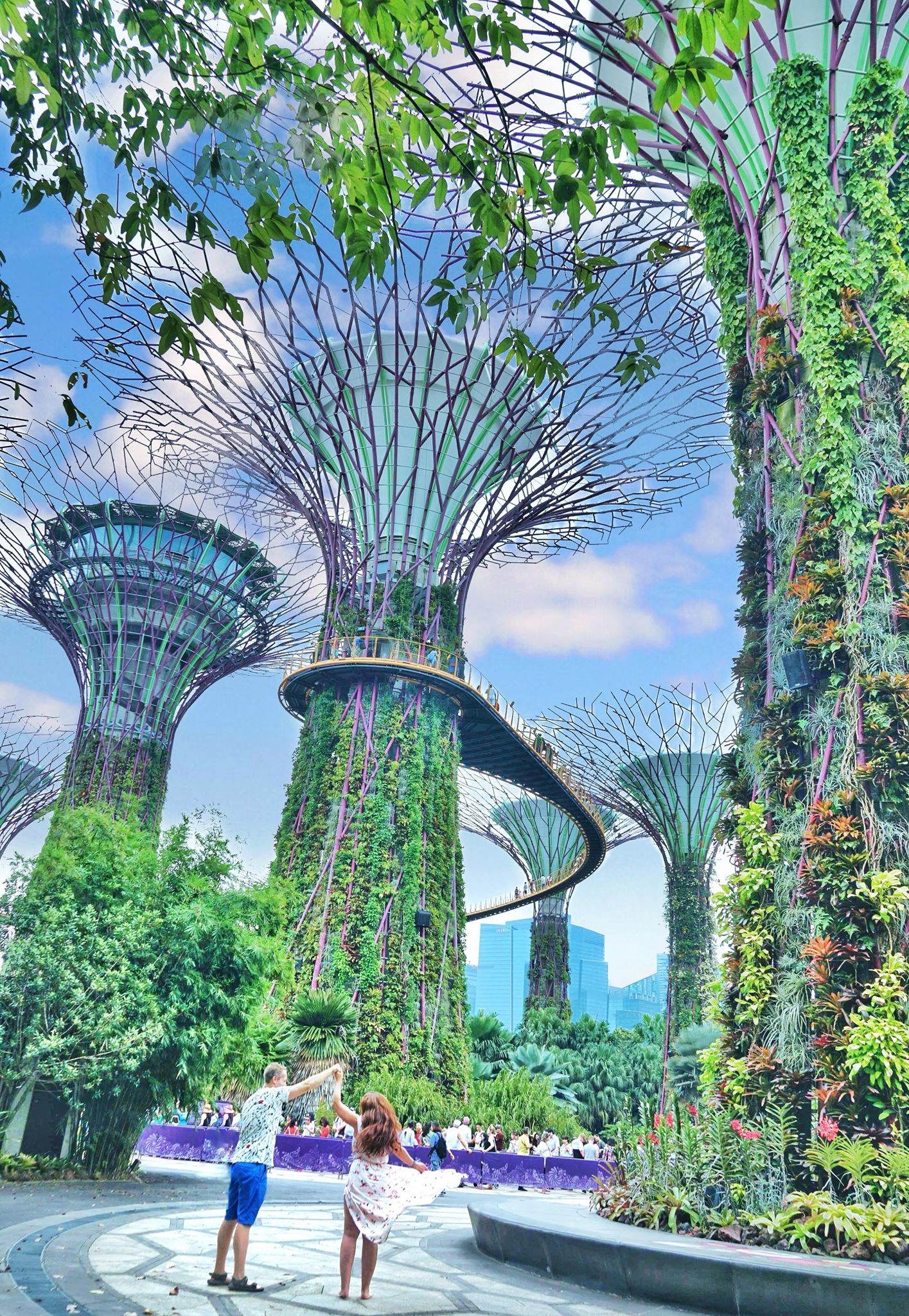 Couple dancing in front of tall trees in Gardens by the Bay