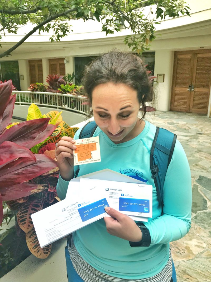Women holding debit cards and lunch vouchers from a timeshare presentation