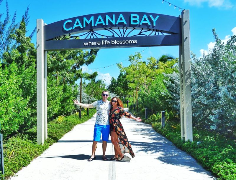 Couple standing under Camana Bay Sign