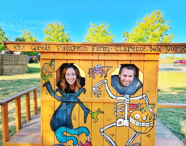 Couple taking a photo with heads in a cut out image