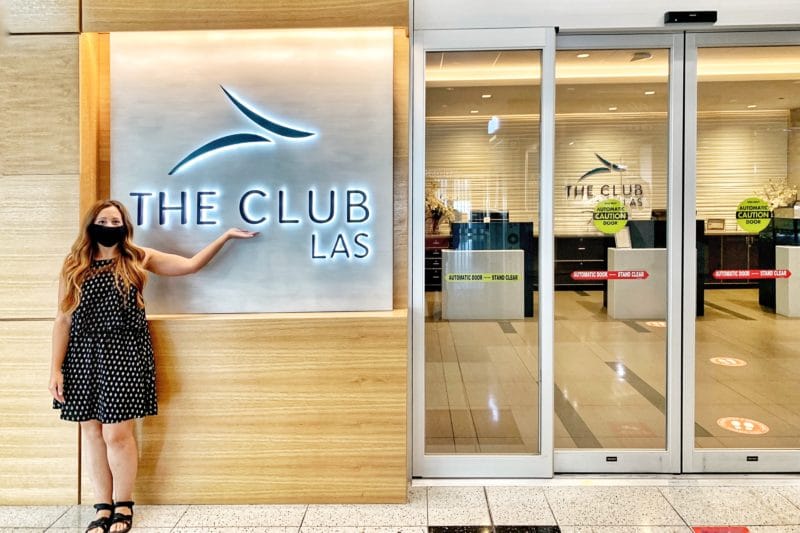 Woman standing infront of The CLUB LAS entryway