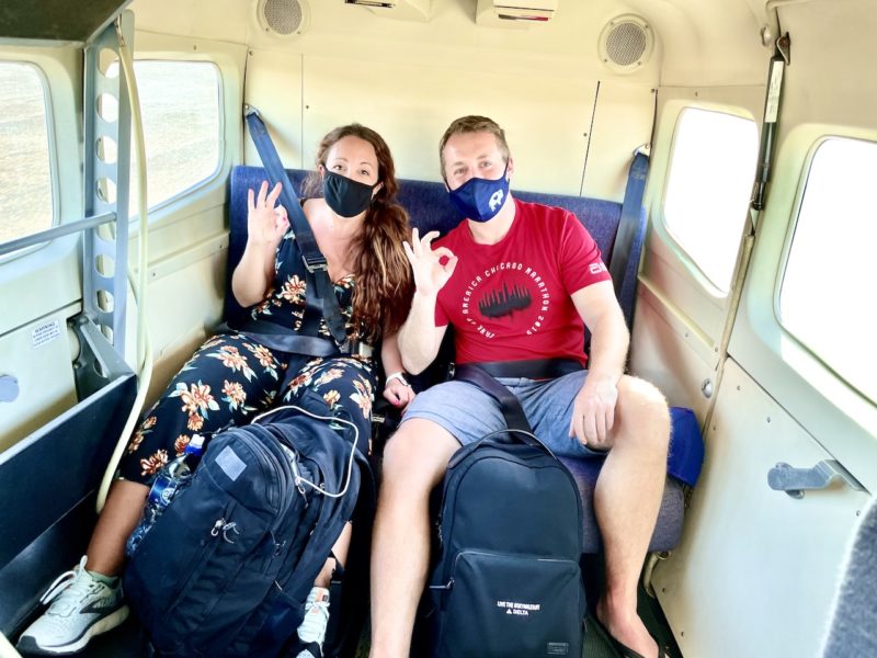 Couple sitting in back of smalll plane