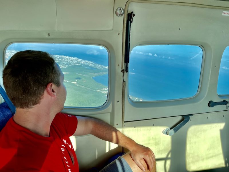 Man looking out window on flight