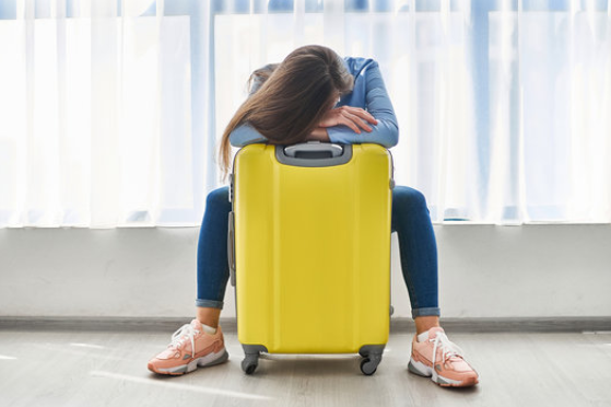 woman with yellow suitcase at airport